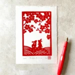 Blossom bunnies linocut print – rabbit wall art by Grace Wong