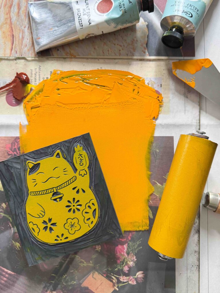 How i produce my linocut prints with a print and orange colour inking process